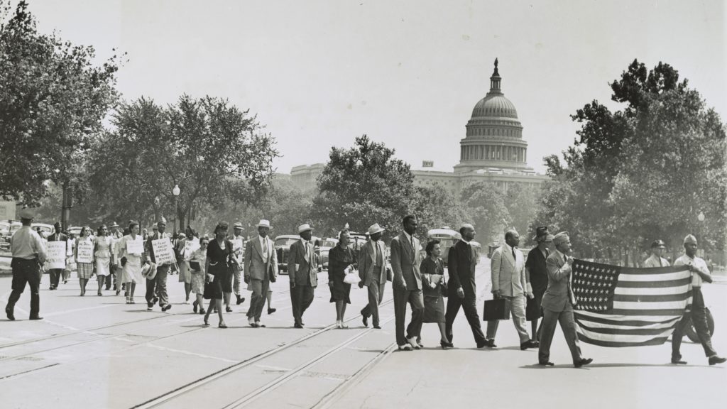 Group of African-Americans, marching near the Capitol building in Washington, D.C., to protest the lynching of four African-Americans in Georgia