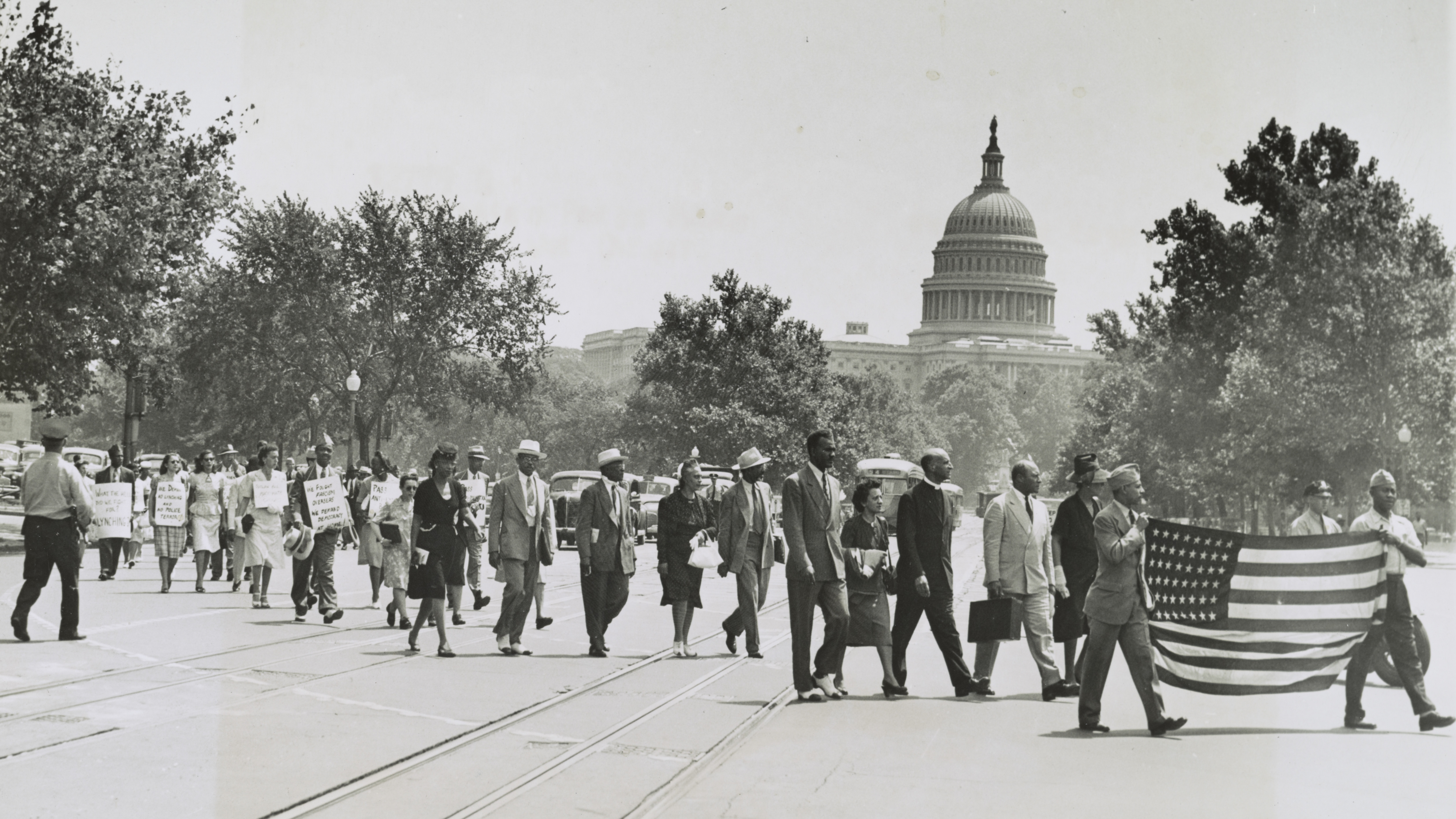 Group of African-Americans, marching near the Capitol building in Washington, D.C., to protest the lynching of four African-Americans in Georgia